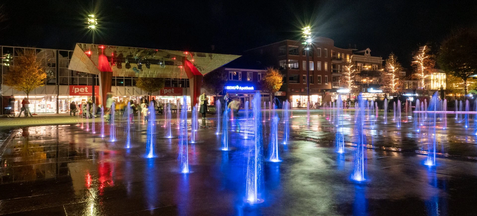 Spektakelfontein Kerkplein Hoogeveen 5 Verlichte fonteinspuiters in blauw licht op het Kerkplein in Hoogeveen in de avond